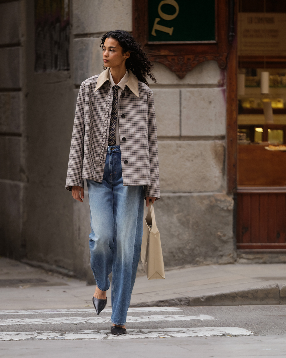 Woman in checked jacket and jeans