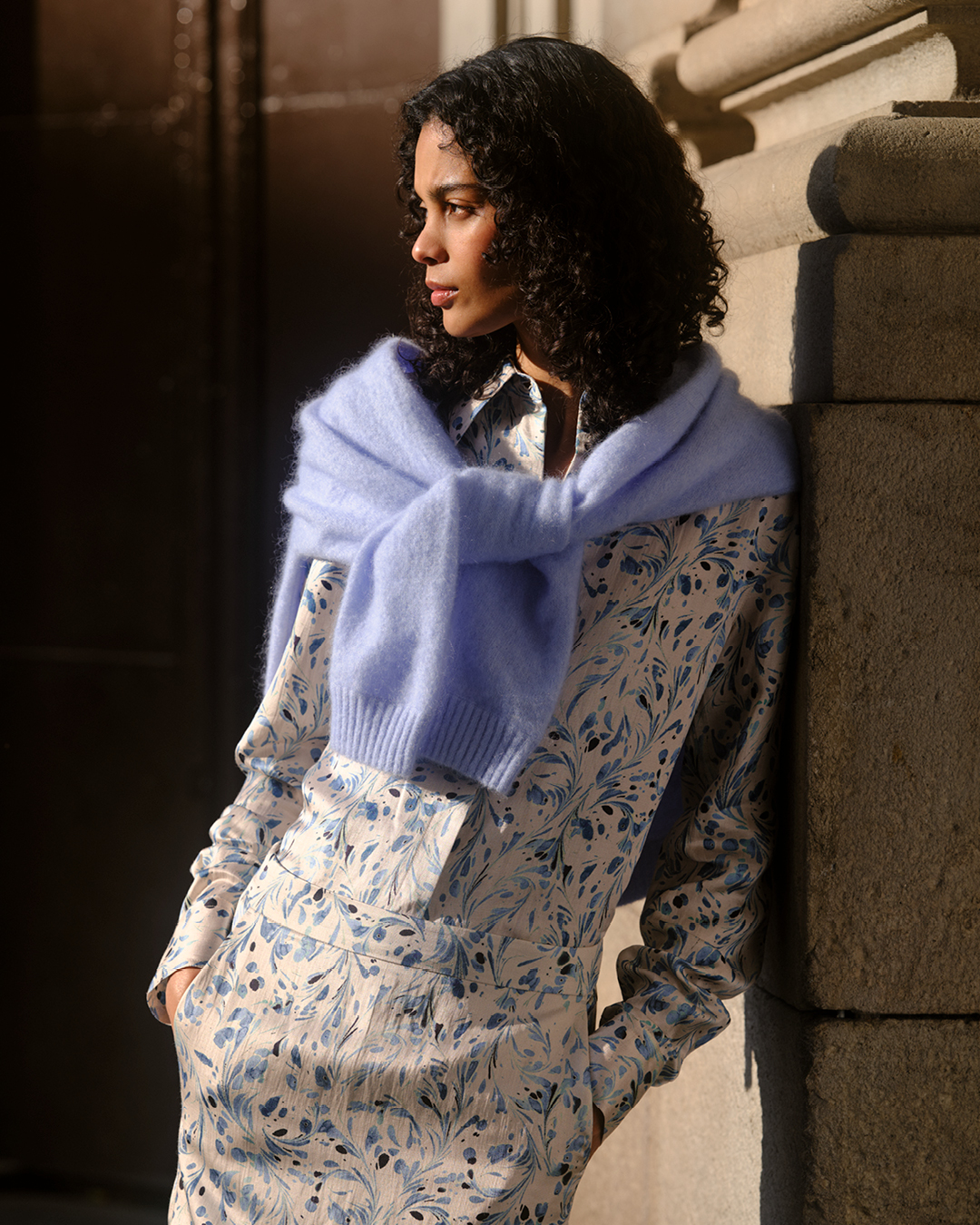 Woman in printed shirt and blue knit