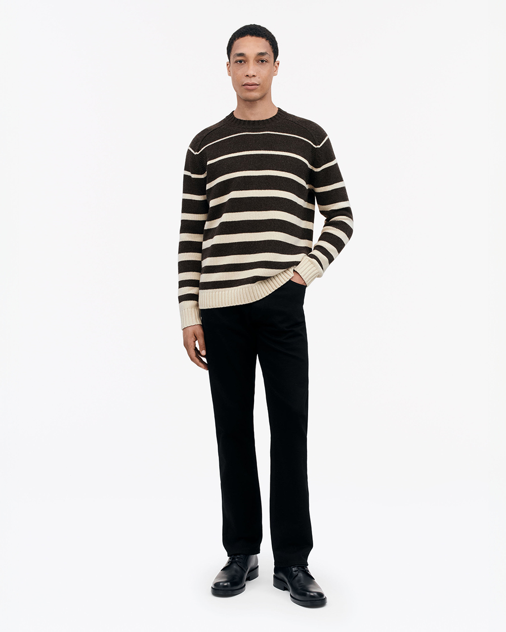 Model in Tiger of Sweden Knit and trousers